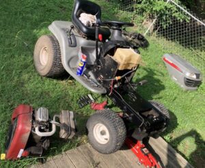 A lawn mower that has been knocked over.