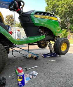 A green tractor with yellow wheels and a blue tire.